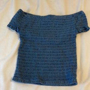 A beautiful blue, off the shoulder, shrilled top in the size small